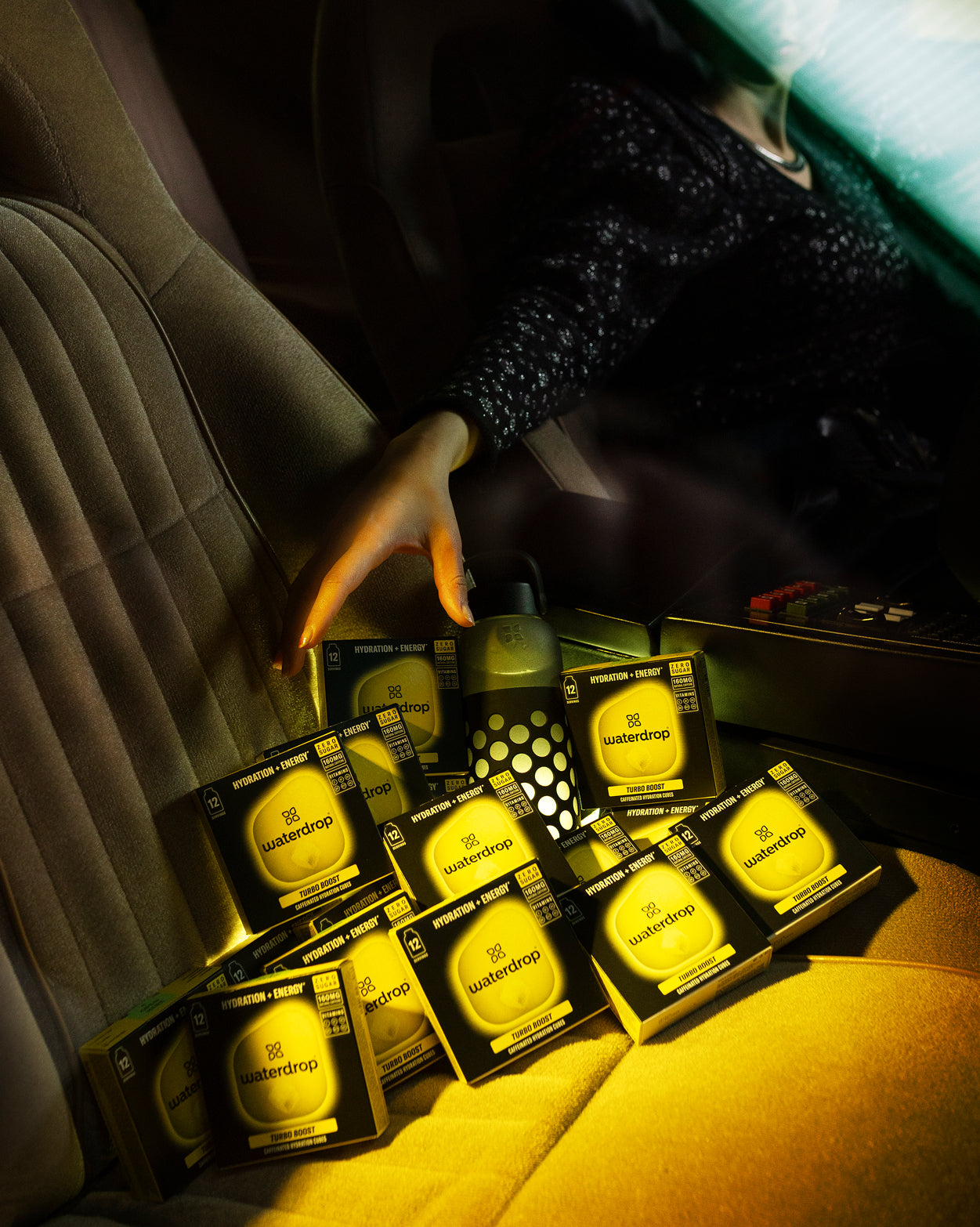 TURBO BOOST cubes and water bottle in car back-seat.